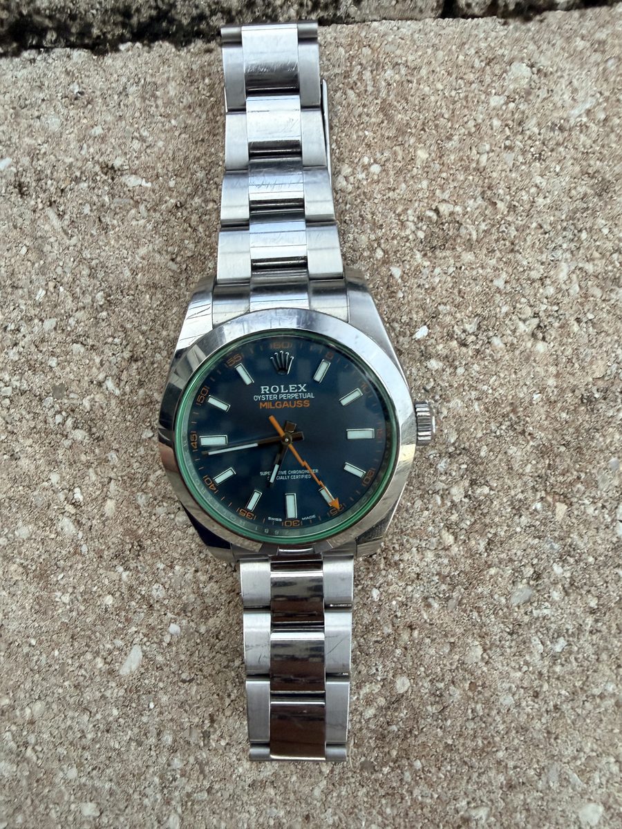 The same watch lying flat on stone, bracelet open, photographed by its owner